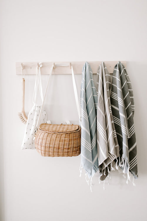 basket and turkish towels hanging on hooks